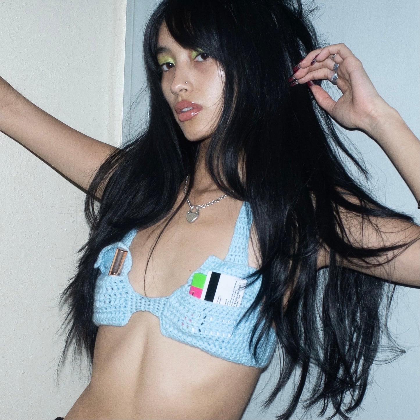 Model wearing the Bailey Prado Envelope Bra, a hand-crocheted baby blue halter top with adjustable neck and back ties.