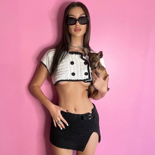 Model wearing the Bailey Prado hand-crocheted black and white cropped cardigan with contrast trim and oversized collar.