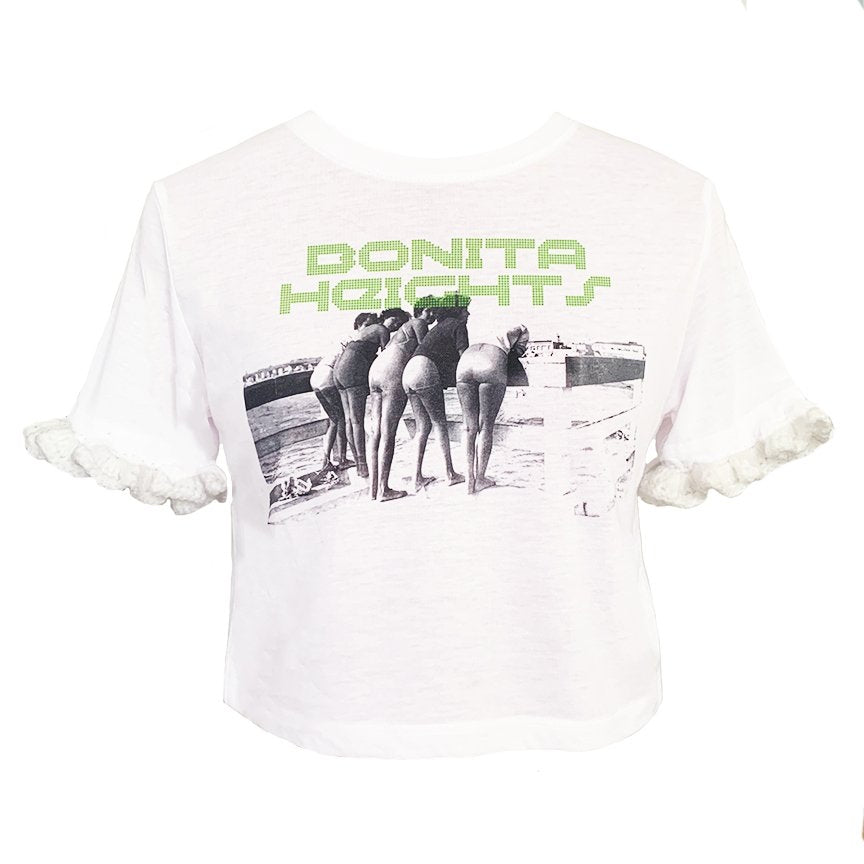 White Baby B graphic tee featuring the "Bonita Heights" print and hand-crocheted ruffle sleeves by Bailey Prado.