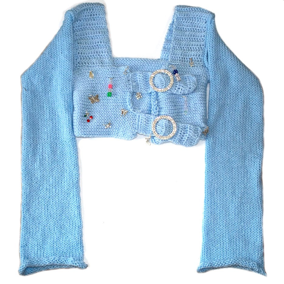 Bailey Prado Blue Long Sleeve Charm Top featuring a baby blue crochet square neck crop top with rhinestone buckle front closures, long sleeves, and mixed charm embellishments.