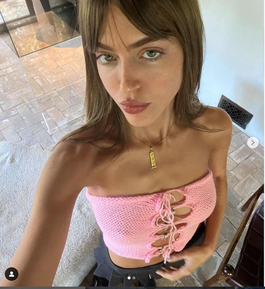 Model wearing the Bailey Prado Kitty Locket Top, a baby blue crochet halter top with functional Hello Kitty locket charms and adjustable halter ties.
