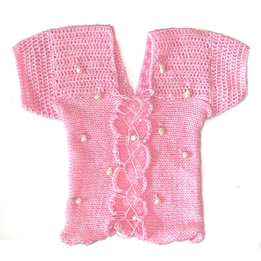 Bailey Prado Pearl Lace Up Top featuring a handmade pink crochet top with a lace-up front and real freshwater pearl embellishments.