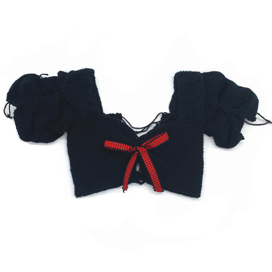 Bailey Prado Plaid Doll Top featuring a black hand-crocheted top with voluminous puff sleeves, a red plaid bow, and adjustable lace-up back.