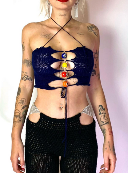 Model wearing the Bailey Prado Pool Ball Top, a navy blue crochet halter top with colorful pool ball charms and an adjustable lace-up front.