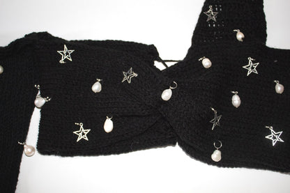 Close-up of the freshwater pearl embellishments, silver star charms, black crochet texture, and adjustable lace-up back on the Bailey Prado Starlight Charm Top.