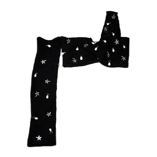Bailey Prado Starlight Charm Top featuring a black crochet twist crop top with freshwater pearls, silver star charms, one off-the-shoulder long sleeve, and an adjustable lace-up back.