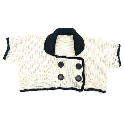 Hand-crocheted black and white cropped cardigan with an oversized collar and double-breasted button closure by Bailey Prado.