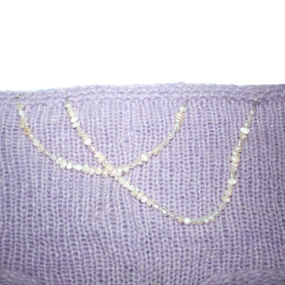 Close-up of the freshwater pearl strap detail on the Bailey Prado Lola Pearl String Shorts.