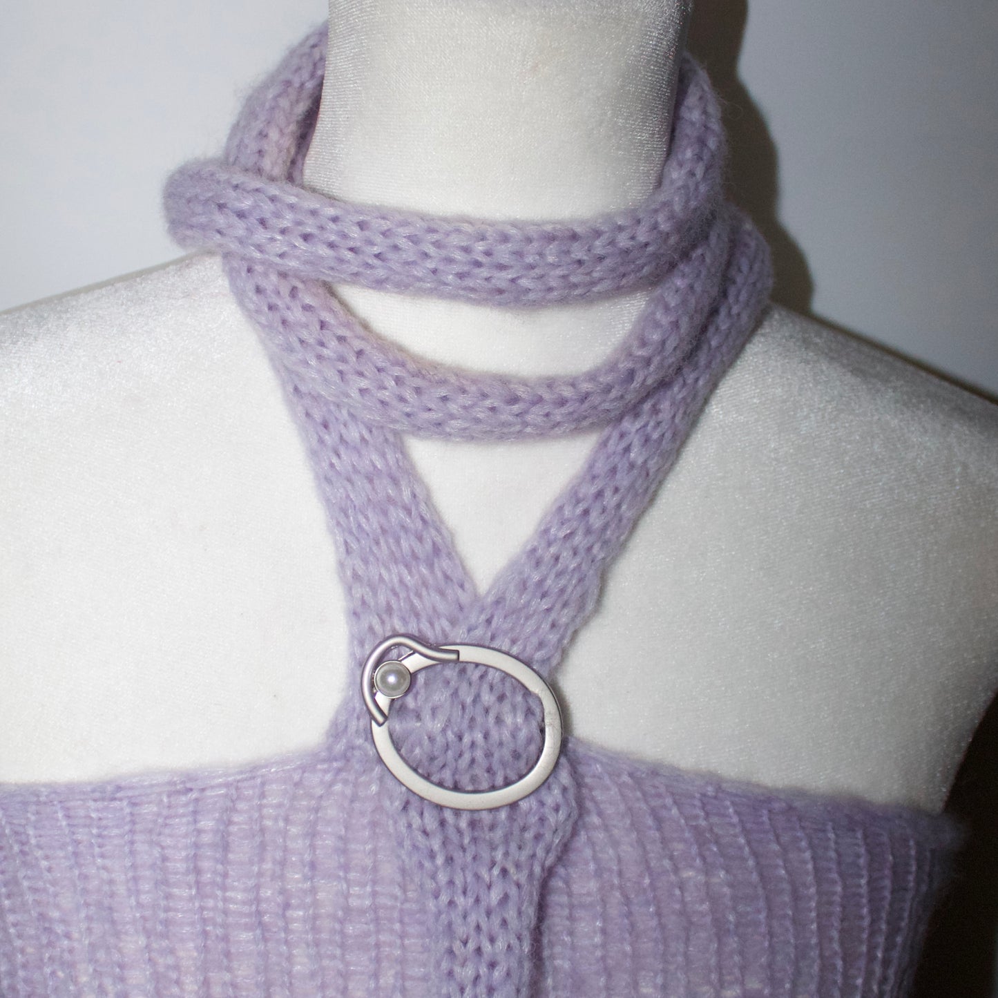 Close-up of the silver buckle detail and soft knit texture on the Bailey Prado Lola Buckle Tank.