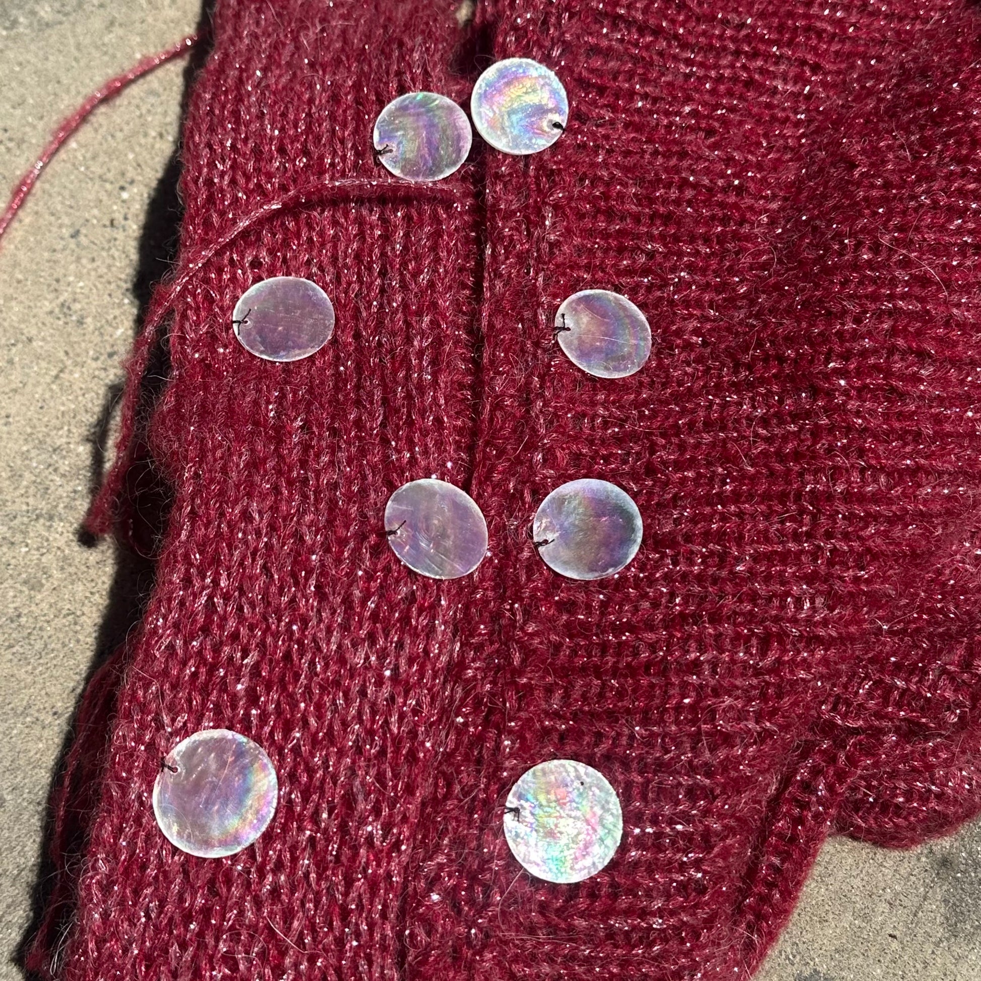 Close-up of handmade knit fabric and shell embellishments on the Bailey Prado Seashell Set.